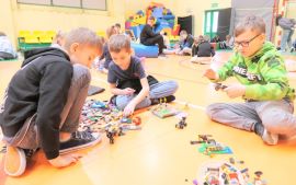 Trzej chłopcy podczas układania klocków lego