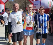 Trzej panowie w strojach sportowych stoją obok siebie 