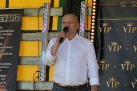 Mężczyzna w białej koszuli podczas przemówienia ze sceny 