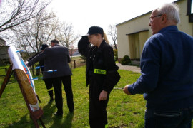 Uczestnik zawodów przy tarczy łuczniczej. Obok stoi druhna z OSP Kietlin