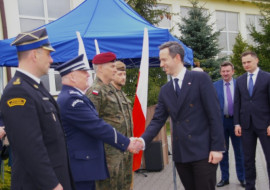 Wiceminister Obrony Narodowej, Marcin Ociepa uściskiem dłoni wita się z mężczyznami 