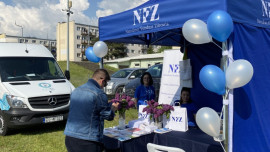 Stoisko wystawiennicze NFZ, przy którym stoi mężczyzna