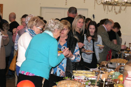 Uczestnicy spotkania w stylu slow food podczas wspólnego spożywania posiłków 