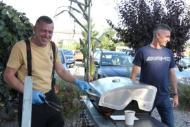 Dwaj mężczyźni. Jeden z nich stoi przy grillu