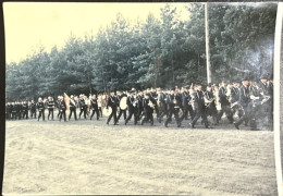 Liczna grupa osób idąca defiladowym krokiem 
