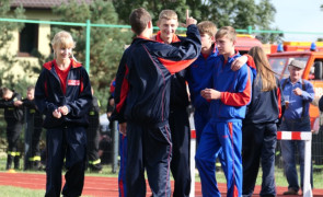 Grupa młodych osób stoi obok siebie 