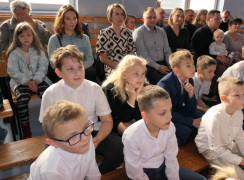 Grupa dzieci siedzi obok siebie
