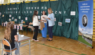 Dziewczynka odbiera dyplom z rąk kobiety