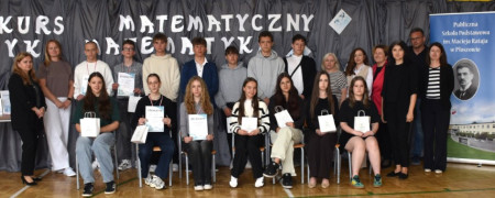 Grupa osób: dorośli i młodzież stoją obok siebie 