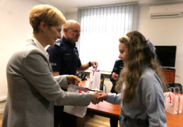 Dziewczynka odbiera prezent od kobiety 